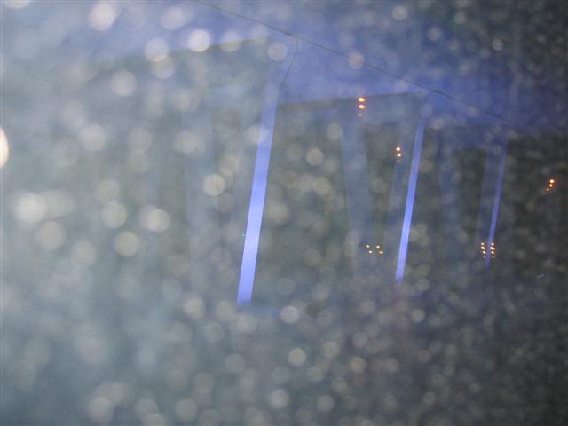 blue building through rainy window